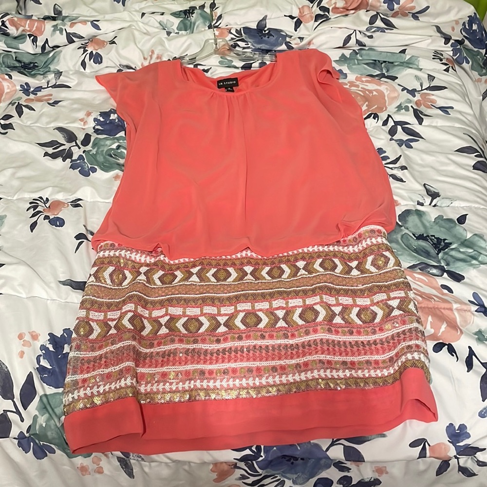 A dress for the spring time. It’s a peach pink on top with a beaded bottom.